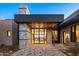 Modern house featuring a paver driveway, desert landscaping, and oversized front door at 36323 N 100Th Way, Scottsdale, AZ 85262