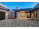 Contemporary home with a paver driveway, stone accents, and an oversized front door at 36323 N 100Th Way, Scottsdale, AZ 85262