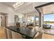 Open kitchen area with a large island, bar stools, and seamless indoor/outdoor living at 36323 N 100Th Way, Scottsdale, AZ 85262