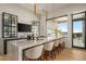 Kitchen bar featuring stone countertops, barstool seating, and indoor/outdoor access at 36323 N 100Th Way, Scottsdale, AZ 85262