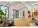 Bright living room with hardwood floors, large windows, modern lighting, and open floor plan seamlessly flowing into the kitchen at 36323 N 100Th Way, Scottsdale, AZ 85262