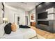 Main bedroom with a fireplace, television, and an adjacent bar/kitchenette at 36323 N 100Th Way, Scottsdale, AZ 85262