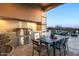 This outdoor kitchen includes a built-in BBQ, dining area, and sink to offer a chef's dream with mountain views at 36323 N 100Th Way, Scottsdale, AZ 85262