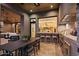 Gourmet outdoor kitchen boasts granite countertops, a gas grill, with barstool seating, and a dining area at 36323 N 100Th Way, Scottsdale, AZ 85262