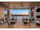 Luxury outdoor living space with fireplace, stylish furniture, pool, and mountain views at 36323 N 100Th Way, Scottsdale, AZ 85262