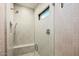 Modern glass-enclosed shower with a built-in bench, multiple showerheads, and stylish tiled walls at 36323 N 100Th Way, Scottsdale, AZ 85262
