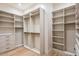 Custom walk-in closet featuring ample shelving, drawers, and rods for organized storage and display at 36323 N 100Th Way, Scottsdale, AZ 85262
