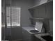 Functional laundry room with a washing machine, shelving, and a window for natural light at 1527 E Germann Rd, San Tan Valley, AZ 85140