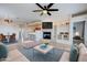 Bright living room featuring a fireplace, built-in shelves, ceiling fan, and open layout leading to the dining and kitchen areas at 11500 E Cochise Dr # 2090, Scottsdale, AZ 85259