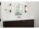 Stylish bathroom with dark wood cabinets and a quartz countertop at 28805 N 114Th St, Scottsdale, AZ 85262