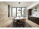 Elegant dining room with a large table, stone accent wall, and natural light at 28805 N 114Th St, Scottsdale, AZ 85262