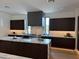 Modern kitchen with dark cabinetry and marble countertops at 28805 N 114Th St, Scottsdale, AZ 85262