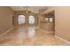 Open-concept living room featuring tile floors, ceiling fan, and ample natural light from large windows at 12122 N Finch Dr, Fountain Hills, AZ 85268