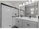 Modern bathroom offers double sinks, a large mirror, and walk-in shower at 18180 W Pima St, Goodyear, AZ 85338