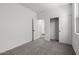 Bright bedroom featuring neutral carpet, white walls, and closet at 18180 W Pima St, Goodyear, AZ 85338