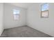 Well-lit bedroom with neutral carpet and large window at 18180 W Pima St, Goodyear, AZ 85338