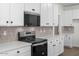 Well-equipped kitchen featuring stainless steel appliances, white cabinets, and laminate countertops at 18180 W Pima St, Goodyear, AZ 85338