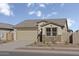 Charming single-story home featuring a two-car garage and stone accents at 18186 W Pima St, Goodyear, AZ 85338