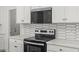 Modern kitchen appliances including a range, oven, microwave, white countertops, and decorative backsplash at 18186 W Pima St, Goodyear, AZ 85338