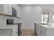 Stylish kitchen with white cabinets, stainless steel appliances, and a decorative tile backsplash at 18186 W Pima St, Goodyear, AZ 85338