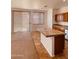 Kitchen island and breakfast bar with tiled flooring at 2932 N 115Th Ln, Avondale, AZ 85392