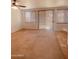 Living room with neutral carpeting and sliding doors at 2932 N 115Th Ln, Avondale, AZ 85392