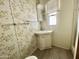 Clean bathroom with floral wallpaper and updated flooring at 318 S Crismon Rd # 82, Mesa, AZ 85208