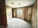 Bright bedroom with wood paneling and carpeted floors at 318 S Crismon Rd # 82, Mesa, AZ 85208