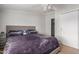Bright bedroom showcasing a cozy bed, a ceiling fan, and ample closet space at 244 N Hawes Rd, Mesa, AZ 85207