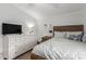 Comfortable bedroom with a wooden bed frame, dresser, and decorative pillows at 244 N Hawes Rd, Mesa, AZ 85207