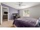 Comfortable bedroom with a large bed, a ceiling fan, and plenty of natural light at 244 N Hawes Rd, Mesa, AZ 85207