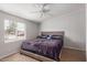 Bright bedroom features a cozy bed, ceiling fan, and a serene atmosphere at 244 N Hawes Rd, Mesa, AZ 85207