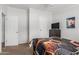 Cozy bedroom featuring neutral walls, a modern TV, and minimalist decor at 244 N Hawes Rd, Mesa, AZ 85207