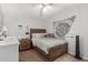 Well-lit bedroom with a wooden bed frame, tapestry, and comfortable furnishings at 244 N Hawes Rd, Mesa, AZ 85207