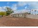 Well-maintained exterior with low maintenance landscaping and white picket fence in the back at 244 N Hawes Rd, Mesa, AZ 85207
