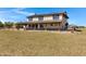 Large backyard with well-maintained grass, fenced perimeter, and a lovely view of the home's exterior at 4880 E Beehive Rd, San Tan Valley, AZ 85140