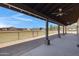 Spacious covered patio with ceiling fans, offering stunning views of the horse property and surrounding landscape at 4880 E Beehive Rd, San Tan Valley, AZ 85140