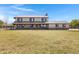 Spacious two-story home with a large front yard and metal roof, surrounded by fencing at 4880 E Beehive Rd, San Tan Valley, AZ 85140