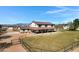 Aerial view of a home with a metal roof, fenced yard, surrounded by grassy areas and mature trees at 4880 E Beehive Rd, San Tan Valley, AZ 85140