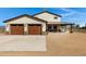 Attached two-car garage with beautiful wood doors and stone accents, complementing the home's exterior at 4880 E Beehive Rd, San Tan Valley, AZ 85140