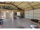Spacious insulated garage with a large bay door and an adjacent room, perfect for storage or a workshop at 4880 E Beehive Rd, San Tan Valley, AZ 85140