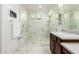 Elegant bathroom with a large walk-in shower, marble tile, and modern vanity at 9503 W Jj Ranch Rd, Peoria, AZ 85383