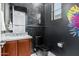 Stylish powder room with dark tile and modern fixtures at 9503 W Jj Ranch Rd, Peoria, AZ 85383