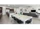 Bright dining area with a white marble table and modern chairs, overlooking the kitchen at 9503 W Jj Ranch Rd, Peoria, AZ 85383