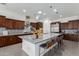 Spacious kitchen with dark wood cabinets, granite countertops, and stainless steel appliances at 9503 W Jj Ranch Rd, Peoria, AZ 85383