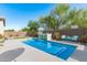 Refreshing backyard pool with a waterfall feature and lush landscaping at 9503 W Jj Ranch Rd, Peoria, AZ 85383