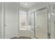 Spa-like bathroom with a glass-enclosed shower and separate tub with tile surround at 3122 E Windmere Dr, Phoenix, AZ 85048