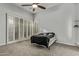 Bright bedroom with carpet and large windows featuring plantation shutters for ample sunlight at 3122 E Windmere Dr, Phoenix, AZ 85048