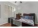 Bedroom featuring wood floors, window shutters and chest of drawers at 3122 E Windmere Dr, Phoenix, AZ 85048