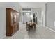 Inviting dining area with an antique wood hutch, complemented by tile floors and white shutters at 3122 E Windmere Dr, Phoenix, AZ 85048
